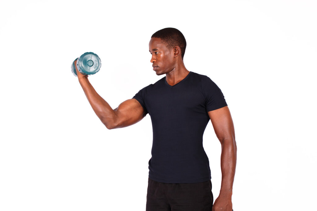 Muscular man curling a dumbbell